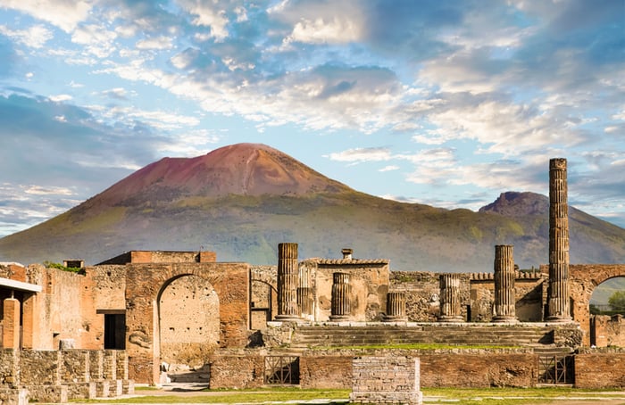 Ancient walls in Pompeii with volcano Vesuvius in the background